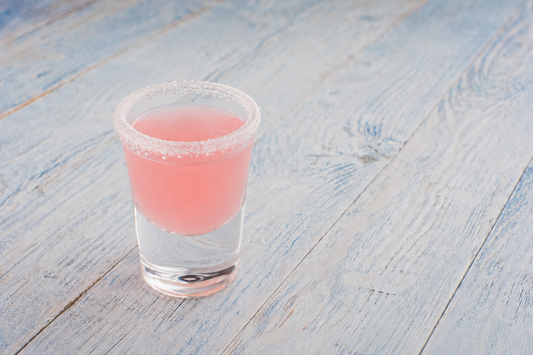 White Tea Starburst Shot in a sugar-rimmed shot glass with a pink hue