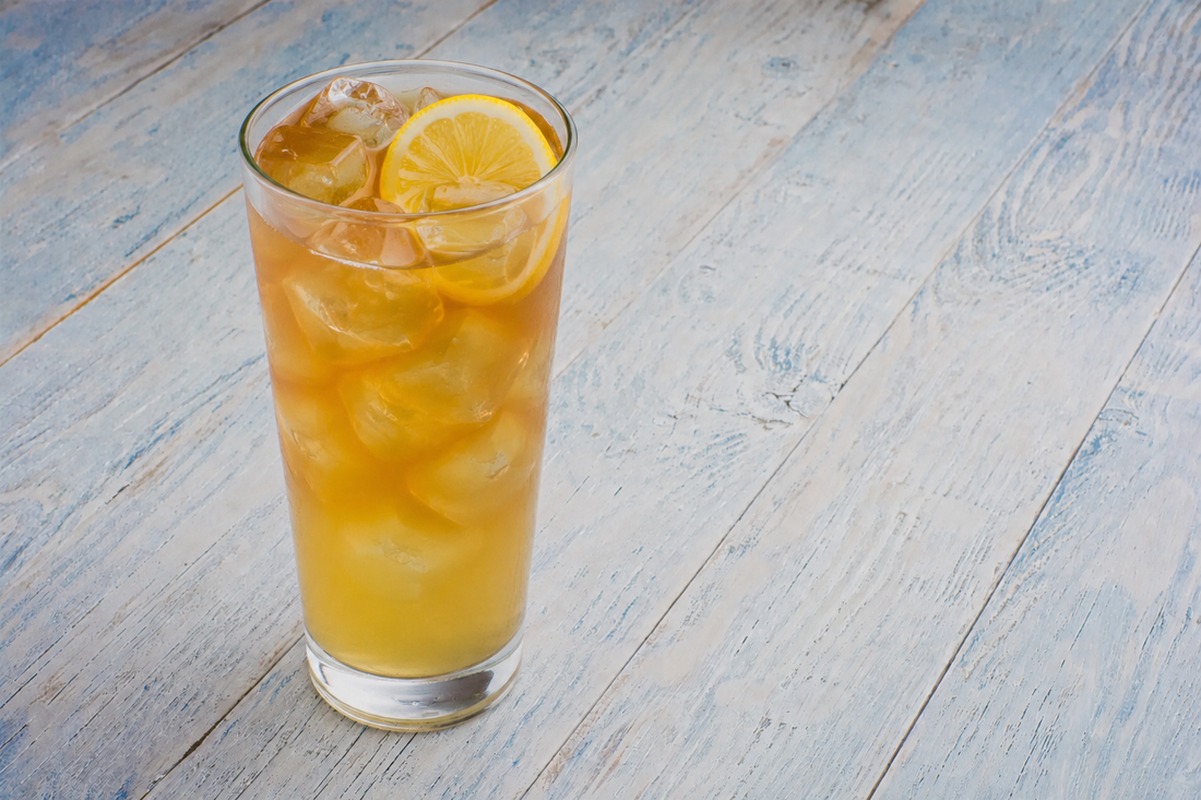 Green Tea Palmer cocktail in a tall glass with ice and a lemon wheel
