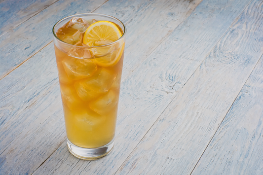 Green Tea Palmer cocktail in a tall glass with ice and a lemon wheel